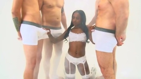Dirty hot ebony young slut on her knees feeding on a bunch of white cocks